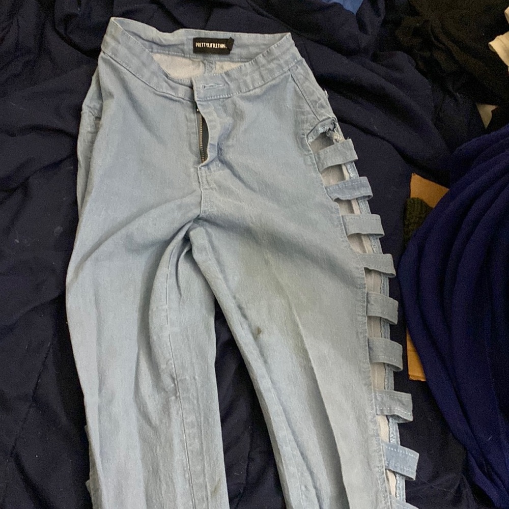 Size 0. Pretty little thing jeans. Blue. Has openings on both legs. 3 stains.